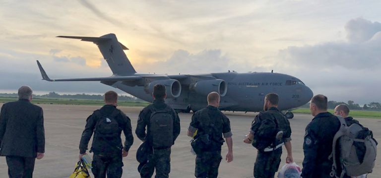 Royal Australian Air Force team walking towards Globemaster aircraft